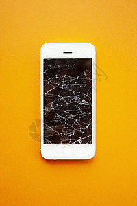 苹果手机碎屏橙色背景上智能手机的碎屏橙子屏幕展示事故休息失败细胞维修碰撞电脑背景