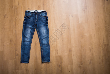 蓝色蓝织物牛仔布服装裤子牛仔裤衣服背景图片