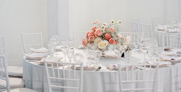 用餐具和花瓶里的鲜花 做婚礼宴席的餐桌 面条彩色装饰品盘子玫瑰刀具玻璃餐巾派对宴会褐色餐厅庆典背景图片