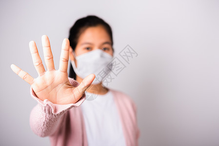 戴外科保护套的妇女面对Coro的面具卫生流感手势棕榈医疗预防白色口罩女孩女性疾病背景图片