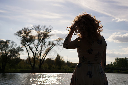 自决以河边的自然为依托的女性形象肖像假期季节游客太阳天空休息旅游太阳镜风景安全背景
