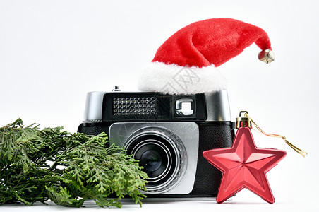摄影师新年 古老的摄影机和新雪花白色绝缘格式六角电影红色星星相机绿色背景图片