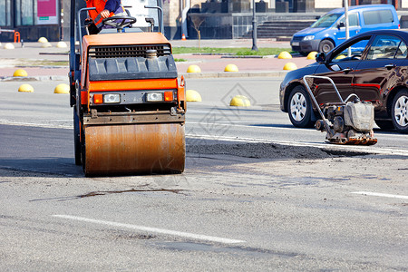 安全锤小型道路设备 一条振动路的滚轮和修车道的拉面工程背景