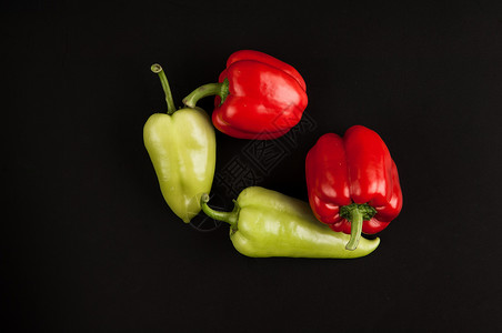 黑色背景的菜种绿色宏观红色胡椒健康蔬菜背景图片