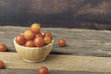 酚类木制桌上一个木质碗店的樱桃西红柿背景