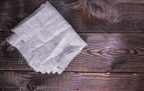 褐木木背景的灰色纸巾纸质感空间材料木板织物桌子木头乡村餐巾厨房背景图片
