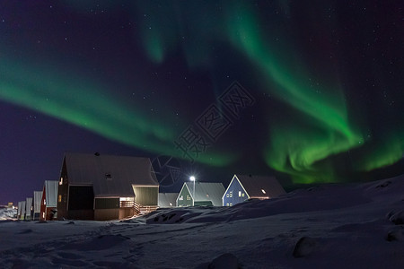 因努伊特人上空的北极村和北光绿浪海洋旅行城市亮度温度天文学北极星村庄小木屋海浪背景图片