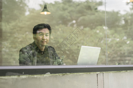 年轻商务人士在办公室用笔记本电脑工作的照片创造力思维人士项目反射商务杯子男人女士背景图片