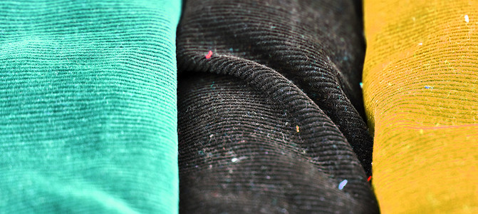 不同布料和织物样品的详细特写视图衬衫丝绸布样样本牛仔布牛仔裤商业市场材料折痕背景图片