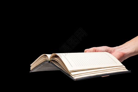 消防安全告知书男性手拿着一张黑背景的空白笔记本教科书电子表格文学手指文档日记阅读笔记背景