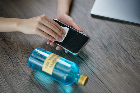 酒精消毒棉片将乙基酒精从瓶中倒到棉片的手宏观伤害治疗男人消毒剂清洁工塑料手指电话药品背景