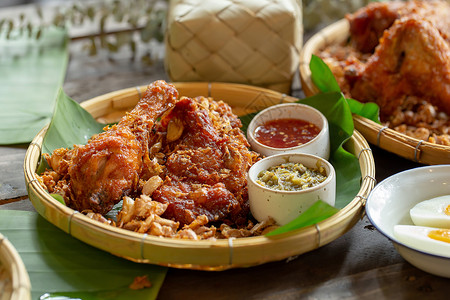 木桌边的大蒜炸鸡烹饪翅膀午餐红色熏制油炸餐厅食物盘子煎锅背景图片