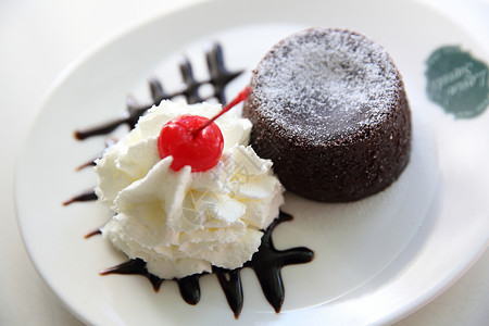 巧克力岩浆蛋糕加冰淇淋糖浆花朵面包餐厅美食自助餐软糖背景食物奶油背景