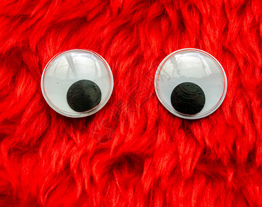 滑稽的谷歌笑笑地毯背景红色怪物眼睛乐趣毛皮玩具眼球爱好黑色卡通片背景图片