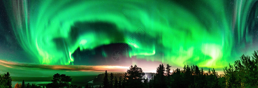 北极光全景 — 部分晴朗的天空和浓雾照耀在瑞典山区雾蒙蒙的森林景观上 绿色的北极光带在地平线上方弯曲 瑞典北部 斯堪的纳维亚背景图片