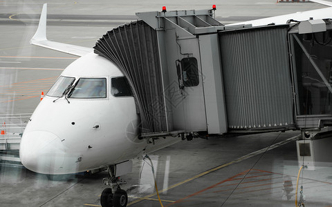 机场上的飞机连接到门套 飞机和套筒 机场门口供乘客登机技术航班方法建筑航空飞机场涡轮人行道假期喷射背景
