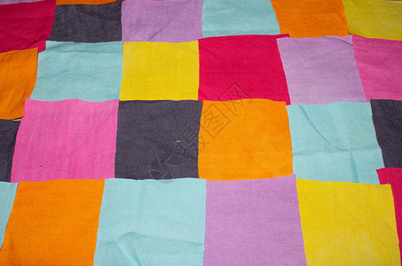 用于背景的彩色织物纺织品碎片橙子墙纸分割下脚料紫色正方形粉色蓝色黄色背景图片