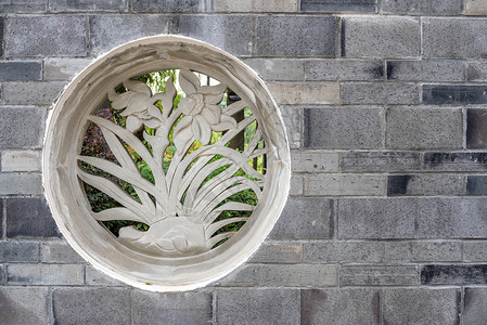 代表砖墙上植物的传统中国石壁画雕塑民众装饰艺术工艺窗户历史文化石头风格背景图片