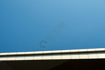 建筑屋顶边缘和蓝色天空上复制空间的平面背景图片
