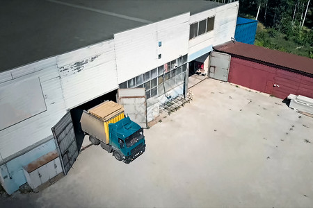 卡车离开机库 货物的运输食物船运天空工厂橙子建筑货车出口汽车店铺背景图片