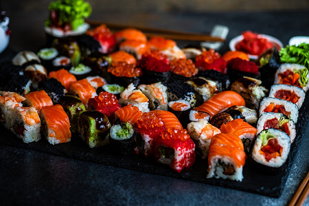 寿司 生生和寿司胶卷贴在石板上执事石头海鲜大豆环境筷子杯子鳗鱼食物鱼片背景