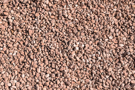 红色的小小卵石粉色地面黏土石头玫瑰团体岩石墙纸鹅卵石材料背景图片