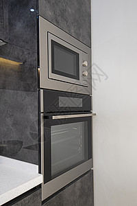 豪华公寓的现代厨房炊具设计房间风格条形装饰器具门把手烤箱金属微波家具背景图片