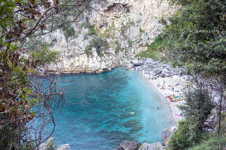 奥皮里奥希腊佩利昂的偏远海滩名为Fakistra树木画报游泳者假期海景海岸鹅卵石蓝色吸引力悬崖背景