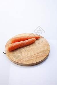 胡萝卜菜板宏观白色植物蔬菜砧板橙子食物背景图片