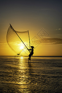 黑影渔民在清晨反射文化日落天空橙子渔夫太阳旅行海洋钓鱼背景图片