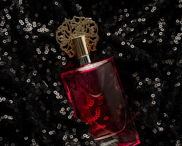 黑底黑色带粉红色香水液的玻璃瓶液体化妆品女性香气奢华女士瓶子香水厂亮片香味背景图片