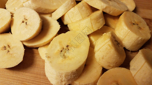 砍柴板上切片白瓜香蕉芭蕉木头砧板木板午餐食物小吃车前草黄色背景图片