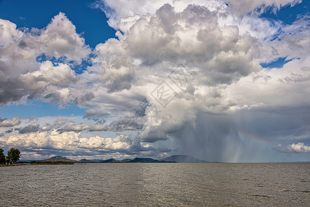 蓝色放射流星雨夏季在匈牙利巴拉顿湖上空的淋浴背景