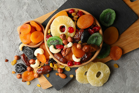 苏丹娜灰色的 有干果和坚果的碗木板李子水果营养小吃桌子食物菠萝榛子饮食背景