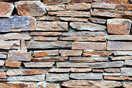 墙的纹理与沙石相隔建筑学力量长方形棕色砂岩花岗岩石头鹅卵石石墙饰面石背景