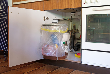 垃圾桶挂在厨房橱柜门上灰色橱柜门合页开场白塑料袋木工金属家具配件塑料背景图片