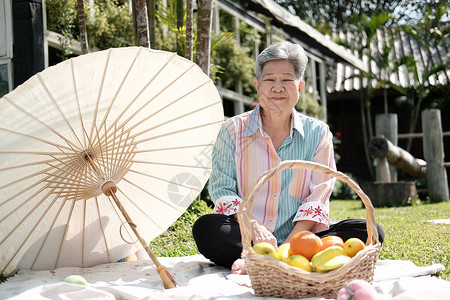 在花园野餐的年长老老女人 年纪大了食物退休闲暇女士花园公园野餐娱乐老年背景图片