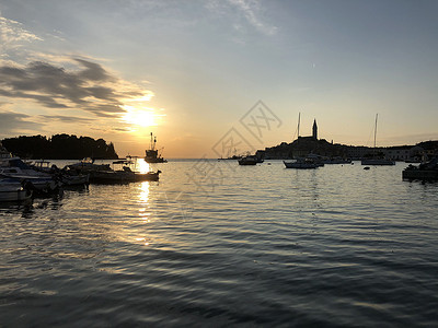 圣尤菲米娅Rovinj 克罗地亚日落钓鱼帆船教会太阳反射假期城市旅游建筑学日出背景