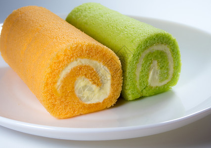 绿色板兰和橙色口味蛋糕派对小吃餐厅美食白色水果甜点味道午餐食物背景图片