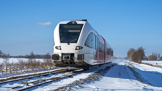 冬季从荷兰出发 在农村开火车去乘火车糖霜交通旅行驾驶白色天气运输铁路场地民众背景图片