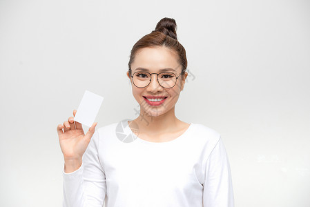 年轻亚洲女性指向白背景的空白卡片商业成人女士微笑女孩背景图片