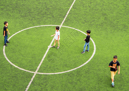 孩子们在休息时间在学校足球场玩耍白色娱乐教育乐趣闲暇草地活动绿色足球操场背景图片