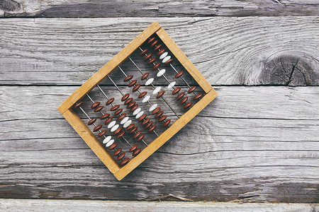 旧板表面上的复古木算盘乐器数数教育平衡经济框架古董会计数字珠子背景图片