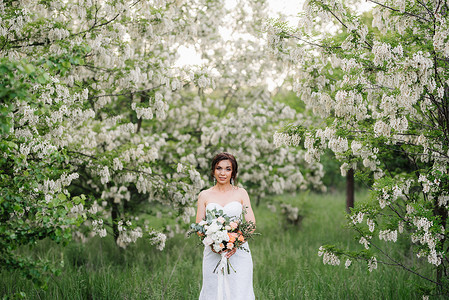 穿着白色衣服的新娘 与大春花束绿色火车家庭幸福裙子婚礼女孩森林喜悦背景图片