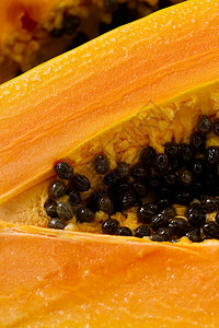 2片美味熟熟的木瓜切成两半合身援助颜色热带健康种子目的橙子异国营养部分背景