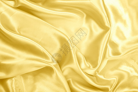 背景纹理上的金色织物缎面液体曲线丝绸墙纸质量褶皱涟漪金子光泽金属背景图片