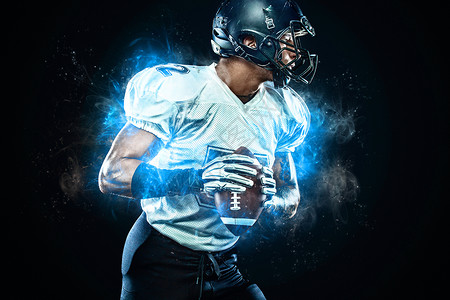 戴头盔的美国足球运动员手上有球 火情背景 团队体育 运动壁纸赛跑者训练游戏大学男人体育场竞技玩家行动力量背景