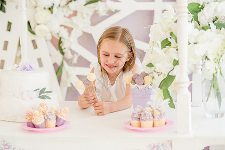 小姑娘在糖果棒里 拿着多彩多彩的甜糖棒棒棒糖糖果庆典酒吧美食甜点装饰微笑奶油风格照片背景图片