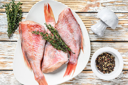 盘子上的全生红色捕鹿鱼 白木背景 顶部视图海鲜美食海洋烹饪营养香料桌子鲷鱼栖息食物背景图片