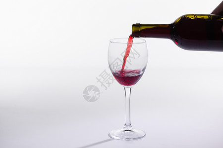 勃艮第葡萄酒红葡萄酒从瓶装倒入大杯子 在白色背景和复制空间上玻璃艺术邀请函液体酒厂瓶子餐厅运动飞溅季节背景